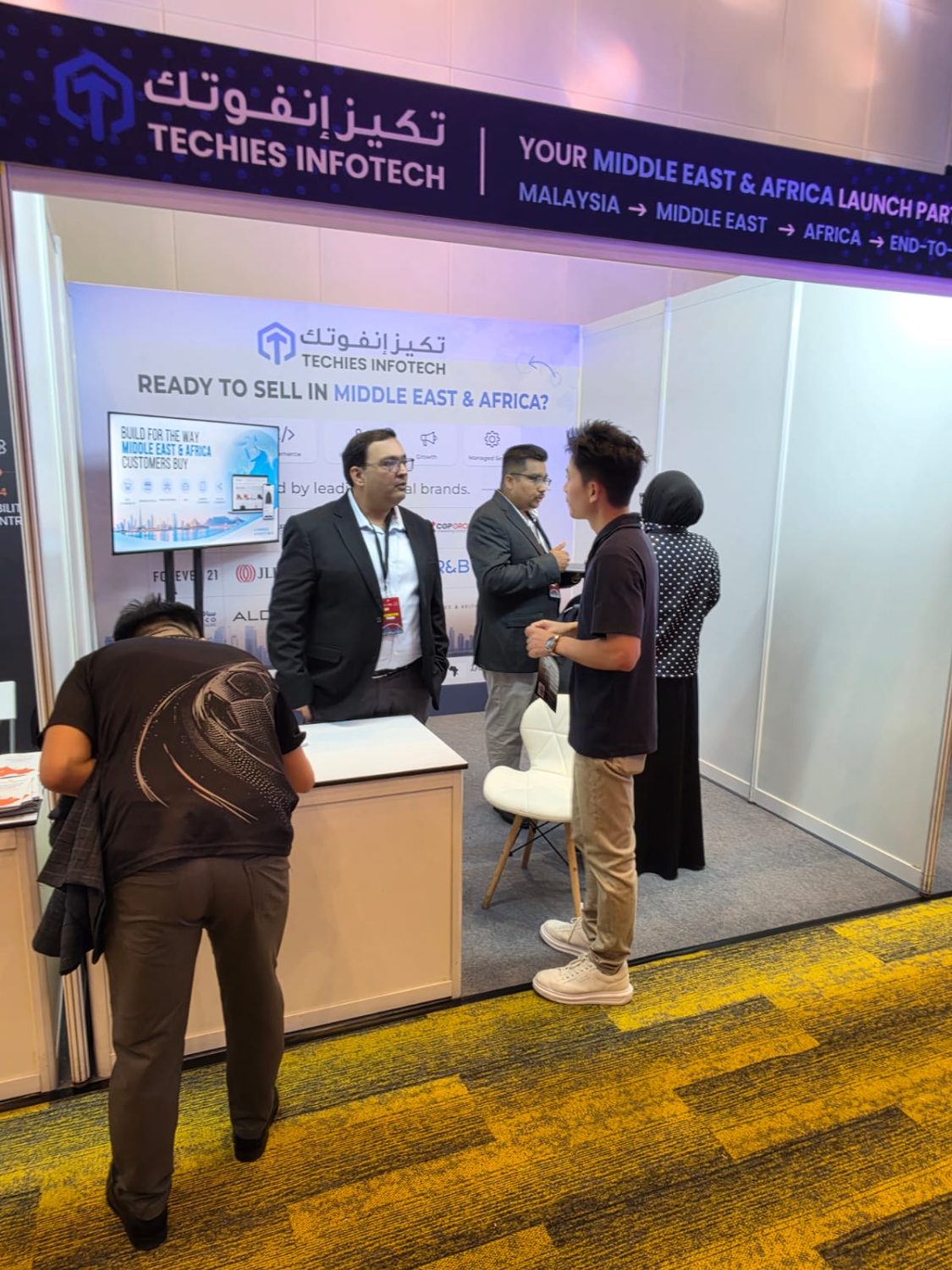 Discussing Middle East and Africa market entry with a visitor at the Techies Infotech booth.